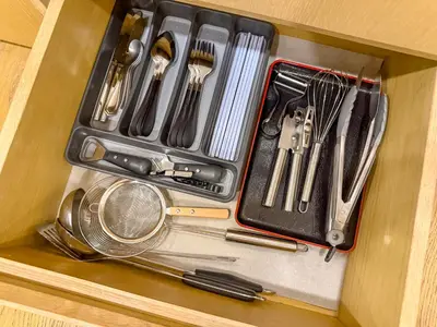 a drawer full of utensils in a cabinet at KLCC Spacious Top Floor, Grand, Slides and Big Bathtub Kula Lumpur in Kuala Lumpur