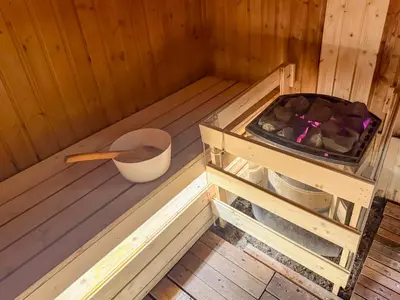 a wooden sauna with a wooden spoon and a bucket at KLCC Spacious Top Floor, Grand, Slides and Big Bathtub Kula Lumpur in Kuala Lumpur