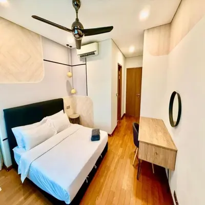 a hotel room with a bed and a table at sky suites klcc by dp in Kuala Lumpur