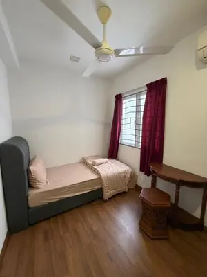 a room with a bed and a table and a window at Happy Homes 1 Kuala Lumpur in Kuala Lumpur
