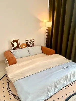 a bedroom with a bed with white sheets at Only Girls Condo at KL city, near monorail in Kuala Lumpur