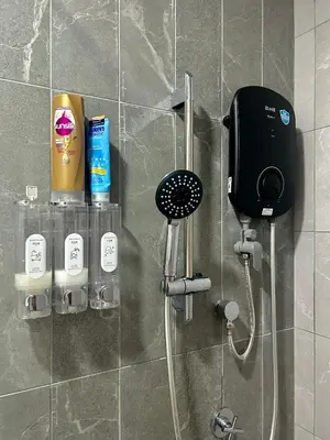 a shower with a phone on a wall at Only Girls Condo at KL city, near monorail in Kuala Lumpur