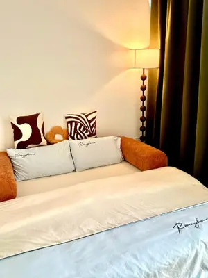 a bed in a room with a couch and a lamp at Only Girls Condo at KL city, near monorail in Kuala Lumpur