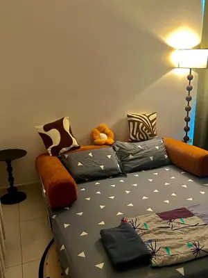 a couch with a teddy bear sitting on top of it at Only Girls Condo at KL city, near monorail in Kuala Lumpur