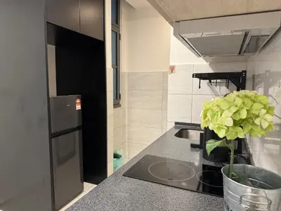 a kitchen with a sink and a vase with a plant at The Robertson N9 Jalan Alor Bukit Bintang Petaling Street 7 Pax in Kuala Lumpur