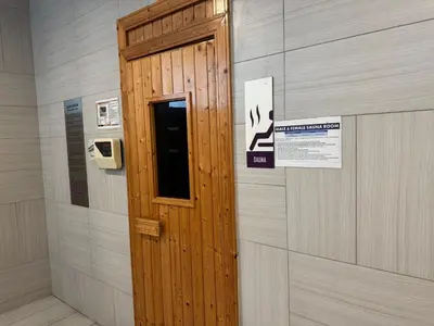 a wooden door in a wall with a sign on it at The Robertson N9 Jalan Alor Bukit Bintang Petaling Street 7 Pax in Kuala Lumpur