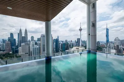 a infinity pool with a view of the city at The Colony By Feel Home in Kuala Lumpur