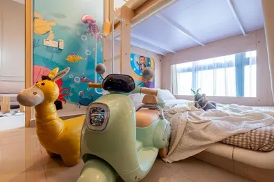 a childs bedroom with a scooter parked next to a bed at The Colony By Feel Home in Kuala Lumpur
