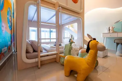 a childs room with a bed and a toy giraffe at The Colony By Feel Home in Kuala Lumpur