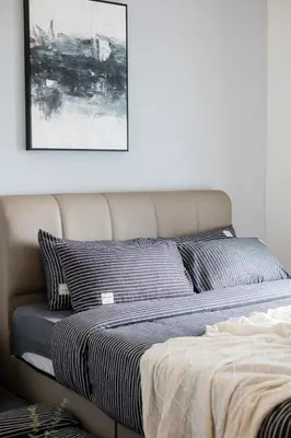 a bed in a bedroom with a picture on the wall at 4 mins to KLCC Luxurious Premium Suite in Three28 in Kuala Lumpur