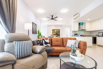 a living room with a couch and a table at 4 mins to KLCC Luxurious Premium Suite in Three28 in Kuala Lumpur