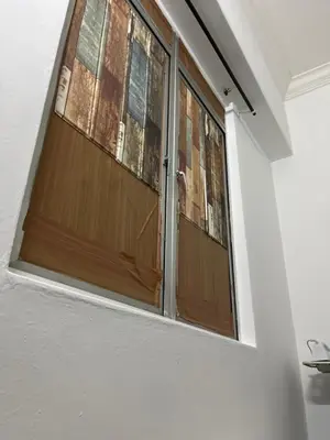 a window with a wooden door in a room at Regalia Residence in Kuala Lumpur