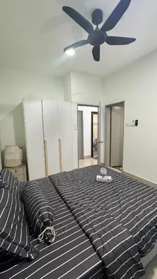 a bedroom with a large bed with a ceiling fan at Razak City Sunset HHhomestay 2R 2B Netflix Utube in Kuala Lumpur