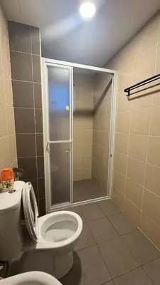 a bathroom with a toilet and a shower with a door at Razak City Sunset HHhomestay 2R 2B Netflix Utube in Kuala Lumpur