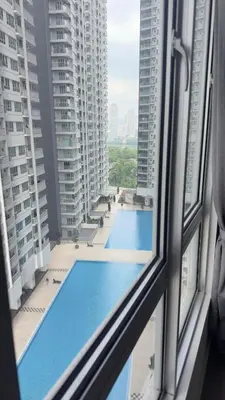 a view of a swimming pool from a window at Razak City Sunset HHhomestay 2R 2B Netflix Utube in Kuala Lumpur