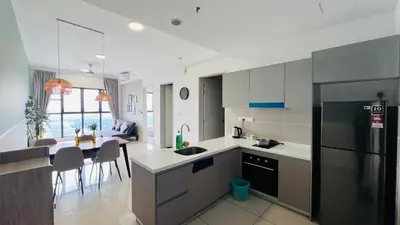 a kitchen with a refrigerator and a dining room at Trion KL Family Residences in Kuala Lumpur