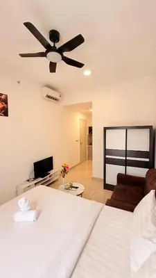 a bedroom with a bed and a ceiling fan at Trion KL Family Residences in Kuala Lumpur