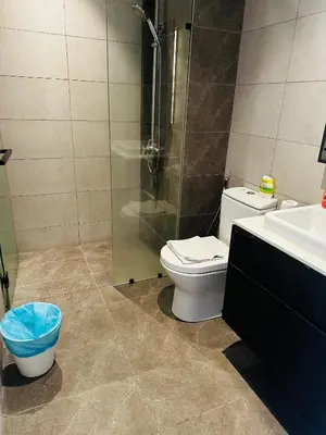 a bathroom with a shower and a toilet and a sink at Crystal At Axon Residence KL in Kuala Lumpur