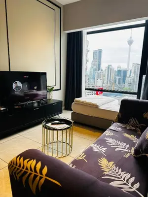 a living room with a bed and a large window at Crystal At Axon Residence KL in Kuala Lumpur