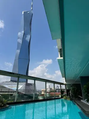 a swimming pool with a tall building in the background at Bukit Bintang By Eryan Guest House in Kuala Lumpur