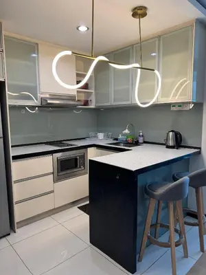 a kitchen with a black and white counter top at Bukit Bintang By Eryan Guest House in Kuala Lumpur