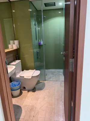 a bathroom with a toilet and a glass shower at SKY suits private room apartments in Kuala Lumpur