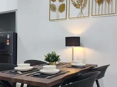 a wooden table with chairs and a lamp on it at Cozy Razak City 2B2B KLCC View Near KL Centre in Kuala Lumpur