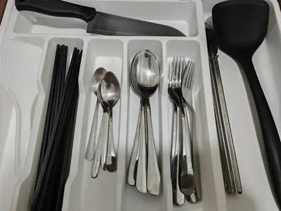 a group of silver utensils on a white tray at Cozy Razak City 2B2B KLCC View Near KL Centre in Kuala Lumpur
