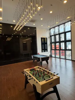 a ping pong table in a room with a pool table at Chamber Residence klcc by Cozy white in Kuala Lumpur