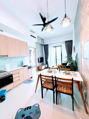 a kitchen and living room with a table and chairs at The Luxe KLCC By Serviced Apartment in Kuala Lumpur