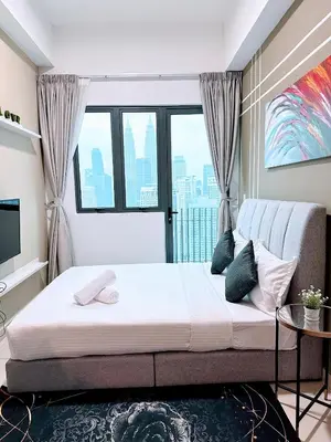 a bedroom with a bed and a large window at The Luxe KLCC By Serviced Apartment in Kuala Lumpur