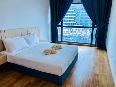 a bedroom with a bed with two teddy bears on it at Supper Suite By Reizz Residence in Kuala Lumpur