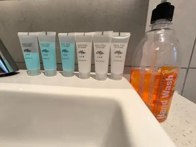 a group of four toothbrushes sitting on a bathroom sink at Tour & Travel Malaysia Axon Residence Bukit Bintang KL in Kuala Lumpur