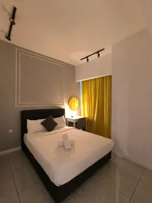 a bedroom with a large white bed and a window at Tour & Travel Malaysia Axon Residence Bukit Bintang KL in Kuala Lumpur