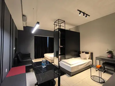 a bedroom with a bed and a table in it at Tour & Travel Malaysia Axon Residence Bukit Bintang KL in Kuala Lumpur