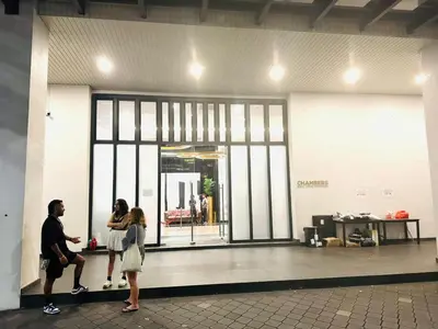 a group of people standing in front of a glass door at Cherry Homes at Chambers by Golden in Kuala Lumpur