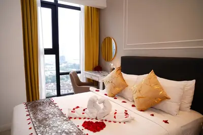 a hotel room with a bed with red hearts on it at Axon Residence KLCC - CK Homestay in Kuala Lumpur