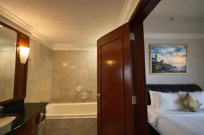 a hotel room with a bed and a bath tub at Signature Stay Times Square, Kuala Lumpur in Kuala Lumpur