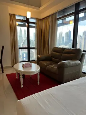 a hotel room with a couch and a table at Apartment TS at Times Square in Kuala Lumpur
