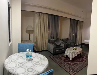 a living room with a couch and a table in a hotel room at Apartment TS at Times Square in Kuala Lumpur