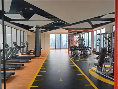 a gym with rows of treadmills and machines at KL Majestic VIP studio Massage Chair 26-1A KLCC view in Kuala Lumpur
