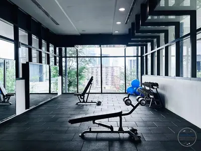 a gym with two chairs and a bench and windows at Lucentia Premium stay Kuala Lumpur in Kuala Lumpur