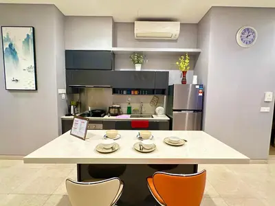 a kitchen with a table with chairs and a counter top at Lucentia Premium stay Kuala Lumpur in Kuala Lumpur