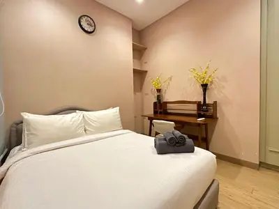 a bedroom with a bed and a clock on the wall at Lucentia Premium stay Kuala Lumpur in Kuala Lumpur