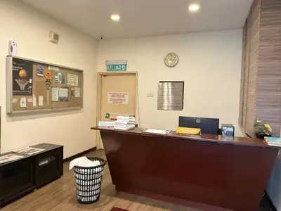 an office with a reception desk with a clock on the wall at Residential Family Apartments At Times Square KL in Kuala Lumpur