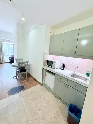 a kitchen with a sink and a microwave at Residential Family Apartments At Times Square KL in Kuala Lumpur