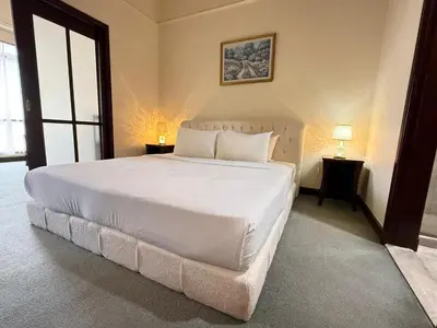 a large white bed in a room with a window at Residential Family Apartments At Times Square KL in Kuala Lumpur