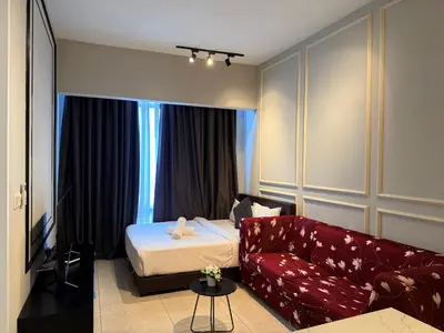 a hotel room with a bed and a couch at Axon Residence KLCC By Premium Suite in Kuala Lumpur