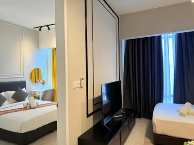 a hotel room with two beds and a mirror at Axon Residence KLCC By Premium Suite in Kuala Lumpur