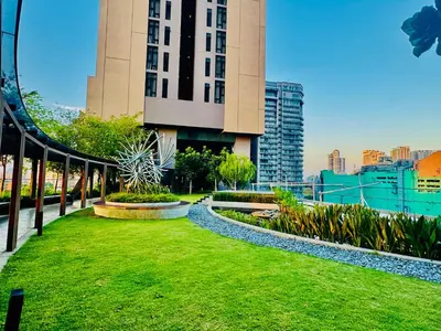 a building with a green lawn in front of it at Axon Residence KLCC By Premium Suite in Kuala Lumpur